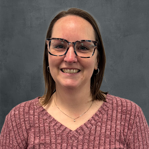 Smiling woman with glasses, sweater