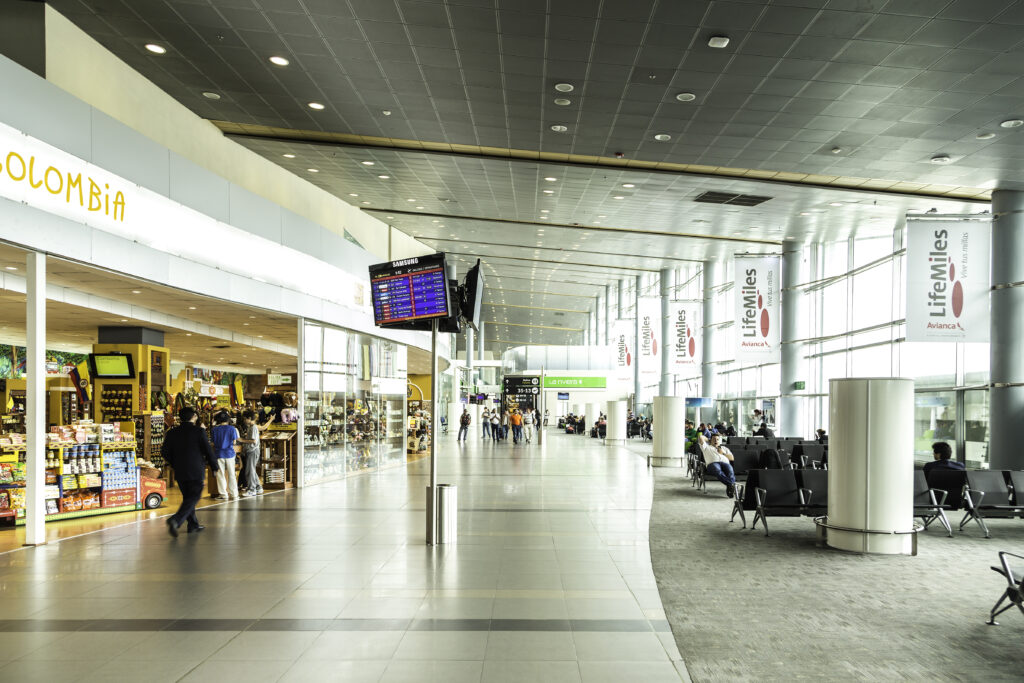 Modern airport terminal with passengers.