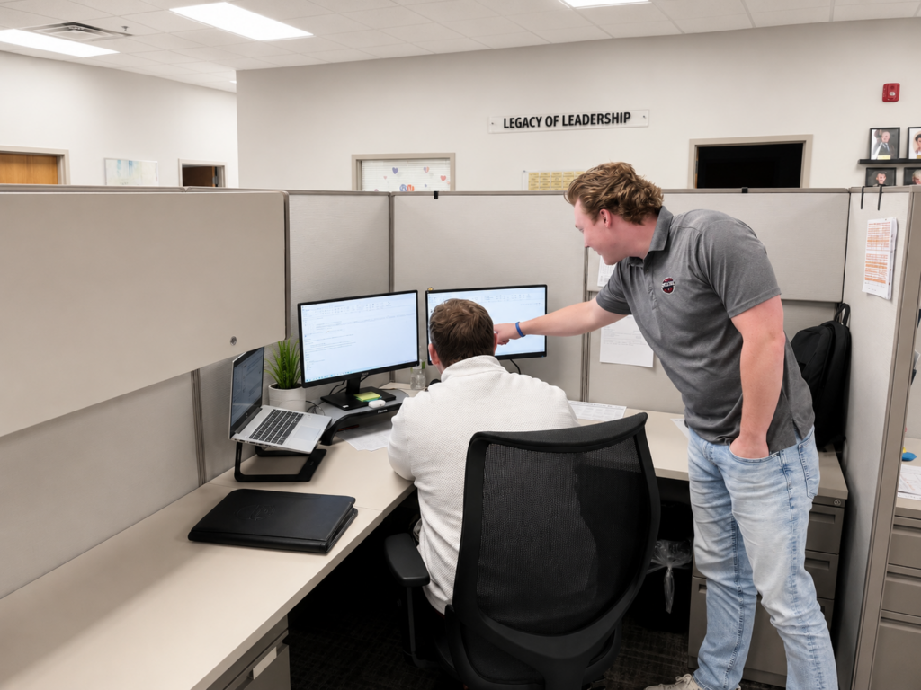 Two people collaborating at office desks.
