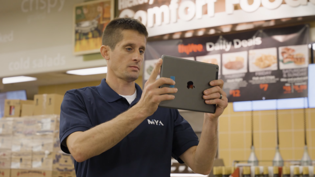 Man using tablet in grocery store