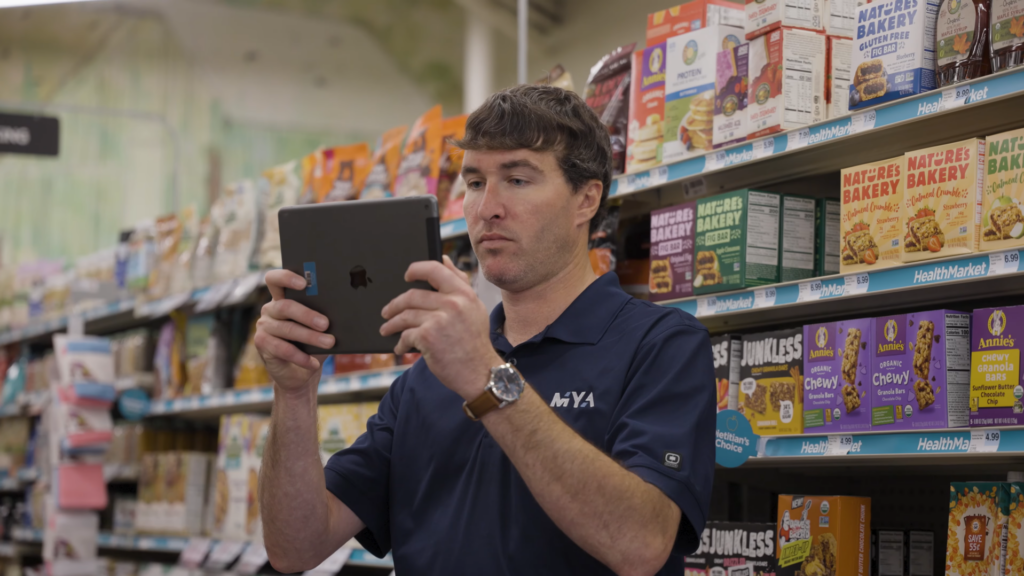 Man using tablet in grocery aisle