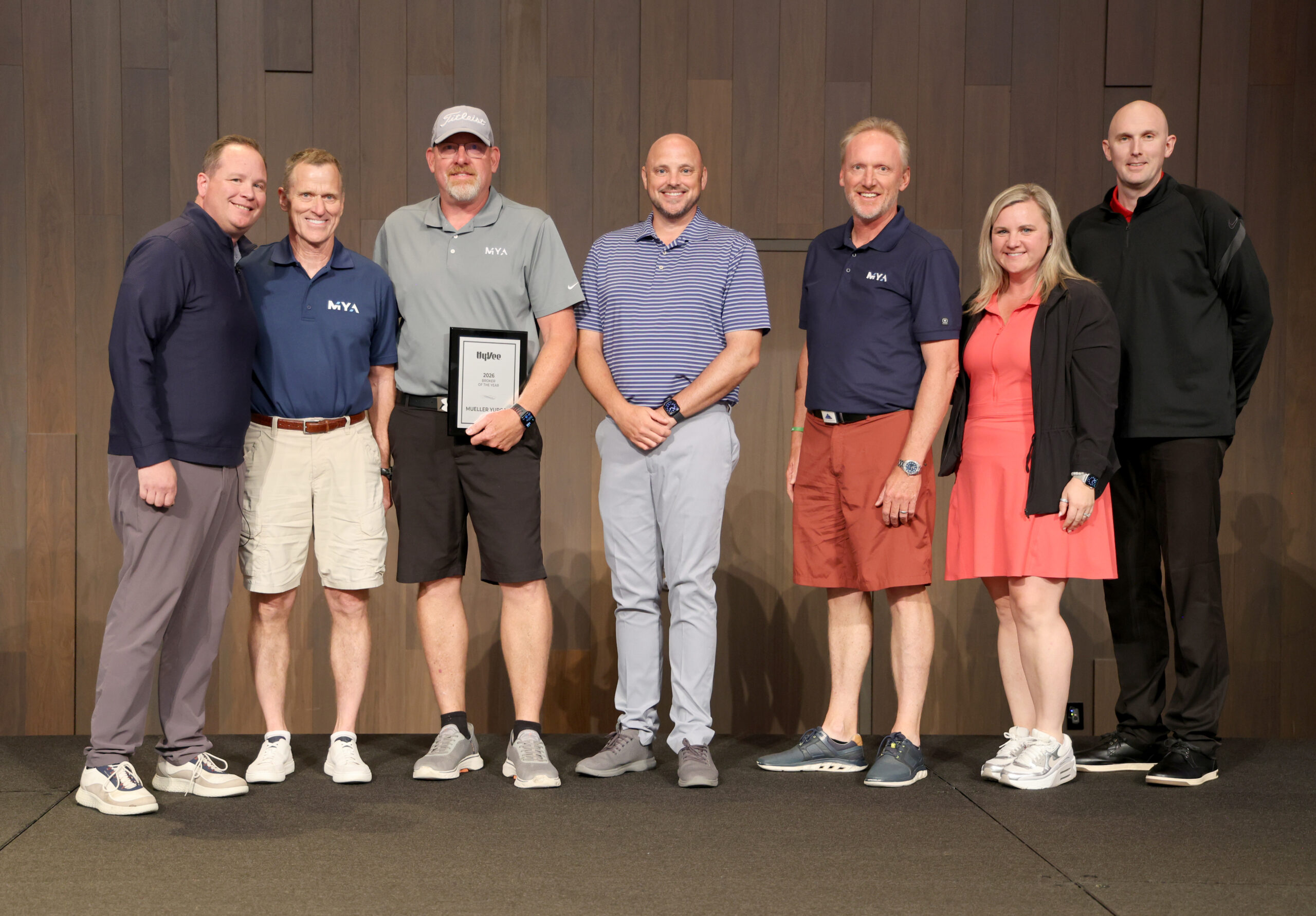 Group of MYA and Hy-Vee Employee accepting an award on a stage